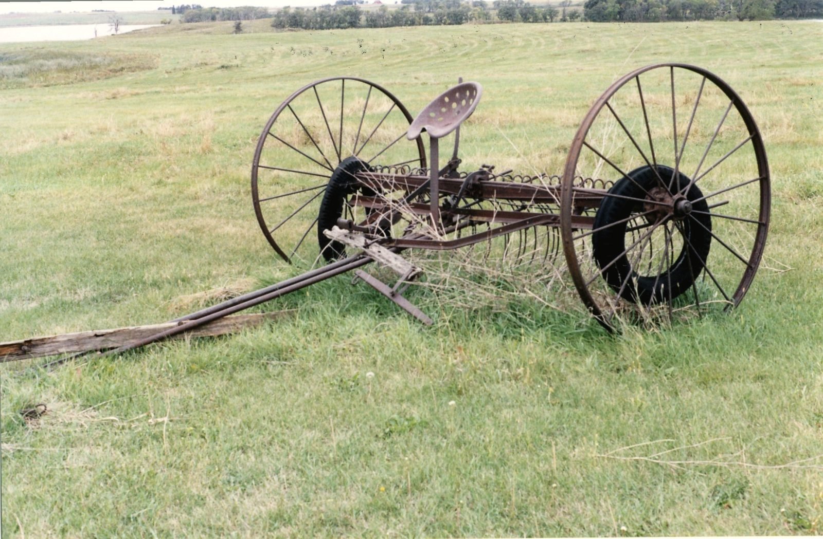 An old horse-drawn hay rake left on open South Dakota prairie